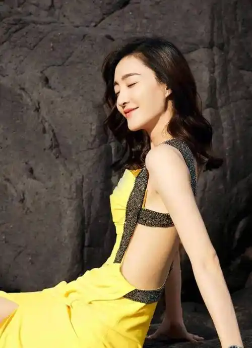 换上一袭白色抹胸衣裙,王丽坤双手拿着化妆品瓶子,露出自己白嫩的香肩