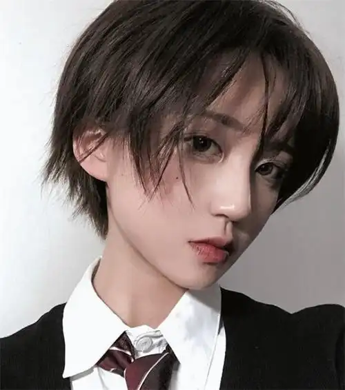 两侧铲青的超短发,上方的发丝用蓝色的发蜡抓出造型感,侧边的雕刻增添