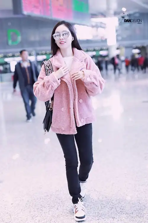 祝绪丹戴墨镜穿粉色外套搭配牛仔裤现身机场,皮肤白皙笑容灿烂